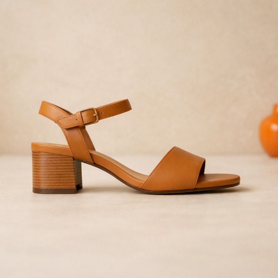 Side profile of a camel leather block-heel sandal showing the stacked heel and sole edge